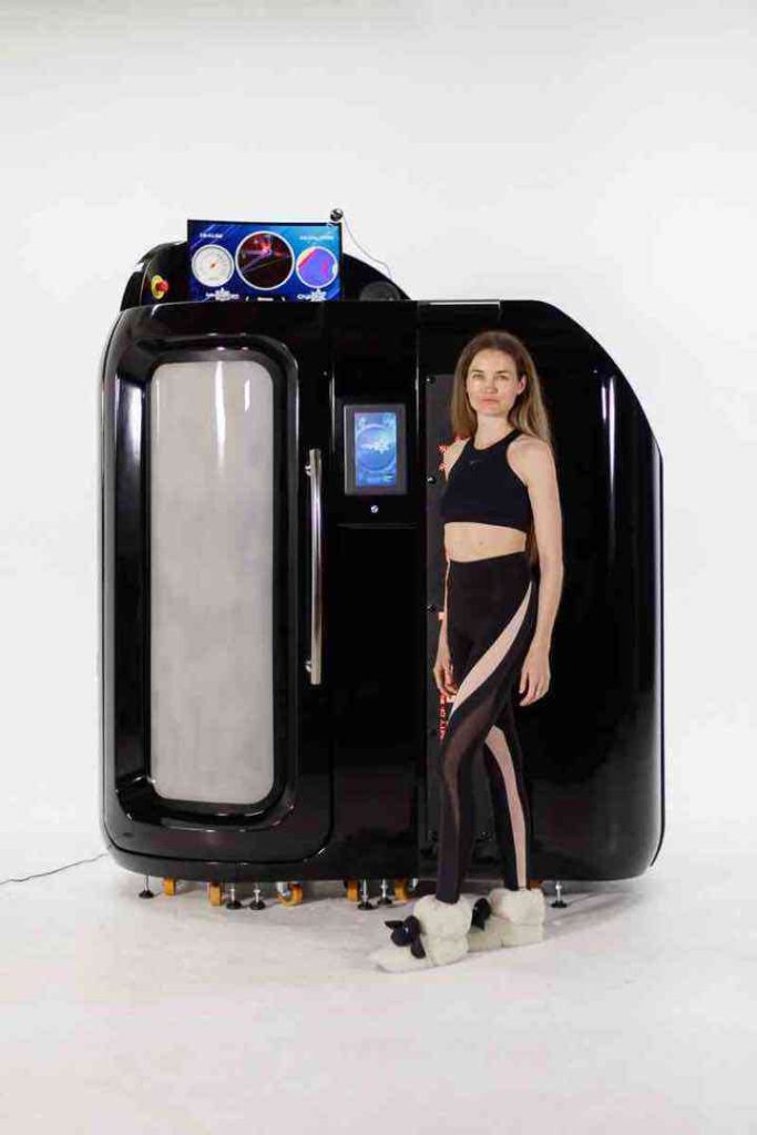 Donna accanto alla camera crioterapica CryoStar